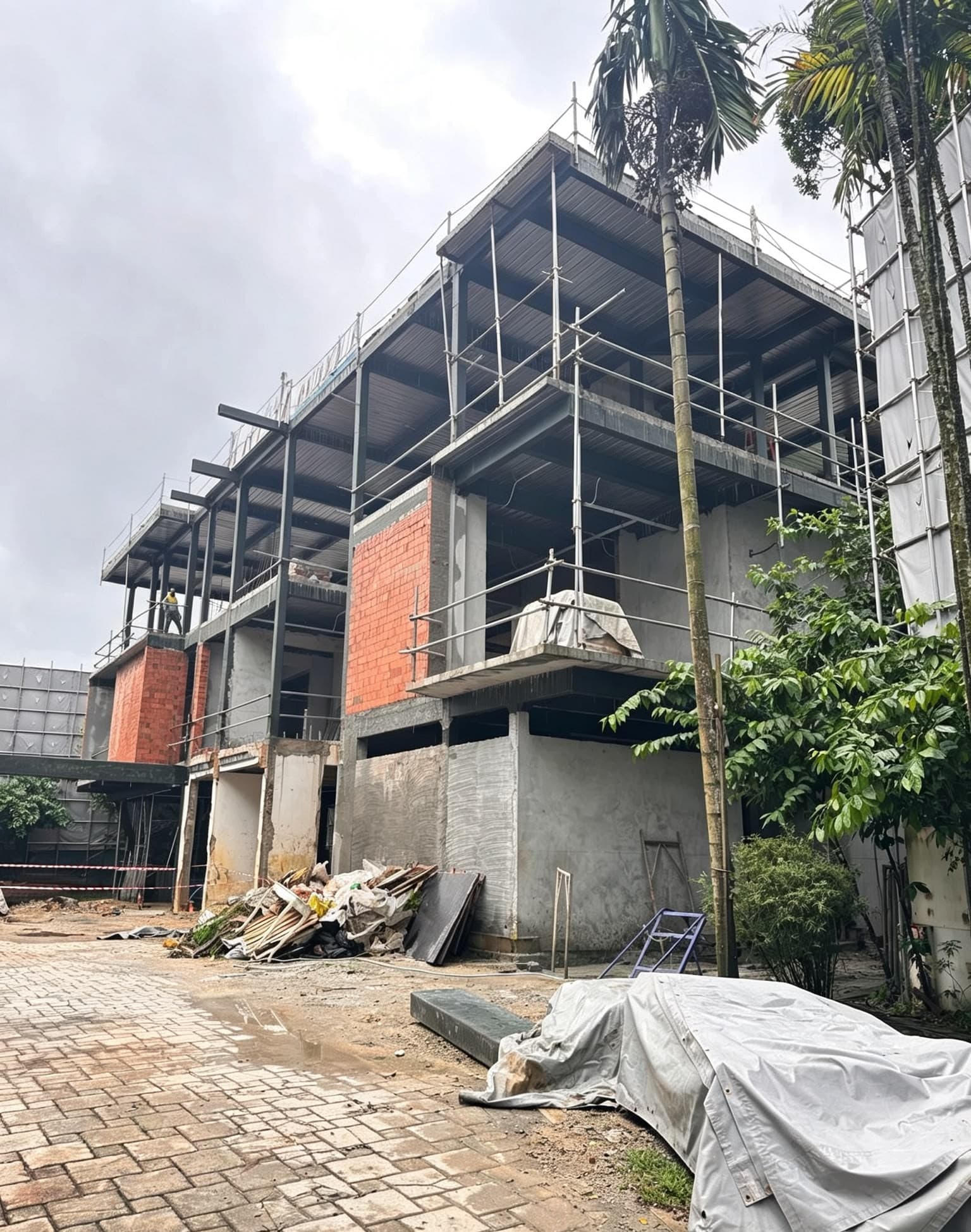 Central-region landed house under active multi-storey construction with scaffolding and structural framing visible.